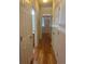 Hallway with hardwood floors and doors leading to various rooms in the house at 9300 E Florida Ave # 608, Denver, CO 80247