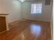 A spacious living room with hardwood floors, a white front door, and a bright window at 9300 E Florida Ave # 608, Denver, CO 80247