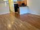 Open living room with hardwood floors leading into the kitchen with black appliances at 9300 E Florida Ave # 608, Denver, CO 80247