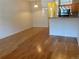An open-concept living room leading to the kitchen, featuring hardwood floors and bright lighting at 9300 E Florida Ave # 608, Denver, CO 80247