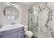 Updated bathroom features a gray vanity, marble shower, and modern fixtures at 7119 S Riviera St, Aurora, CO 80016