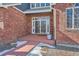 Covered front porch of a brick home with glass paned doors and sidelights at 7119 S Riviera St, Aurora, CO 80016