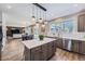 Open kitchen boasts a quartz island, stainless appliances, and a view into the living room at 7119 S Riviera St, Aurora, CO 80016