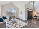 Bright living room features a vaulted ceiling, large windows, and a modern geometric rug at 7119 S Riviera St, Aurora, CO 80016