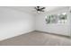 Empty bedroom features neutral paint and flooring, a ceiling fan, and a large window at 2232 Coronado Pkwy # B, Denver, CO 80229