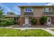 Charming townhome exterior with brick accents and well-maintained lawn at 2232 Coronado Pkwy # B, Denver, CO 80229
