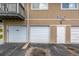 Garage doors for parking with signage and service door at 2232 Coronado Pkwy # B, Denver, CO 80229
