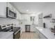 Updated kitchen with stainless steel appliances, bright countertops, and white cabinets at 2232 Coronado Pkwy # B, Denver, CO 80229