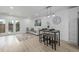 Bright living room with wood floors, white sofa, and glass doors leading to the patio at 2232 Coronado Pkwy # B, Denver, CO 80229