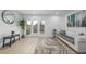 Bright living room with wood floors, white sofa, and glass doors leading to the patio at 2232 Coronado Pkwy # B, Denver, CO 80229