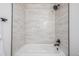 Bathtub shower with updated neutral subway tile and black hardware at 2232 Coronado Pkwy # B, Denver, CO 80229