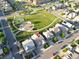 Real estate aerial view showcasing the property's location near a community park with playground and sports court at 5425 E 125Th Pl, Thornton, CO 80241