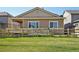 A backyard with a well-maintained lawn, a wooden fence, a ramp, and a covered patio at 5425 E 125Th Pl, Thornton, CO 80241