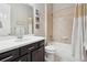 Bathroom with a vanity, shower-tub combo, and neutral tile at 5425 E 125Th Pl, Thornton, CO 80241