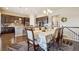 Elegant dining area featuring hardwood floors, chandelier, and a view into the adjacent kitchen area at 5425 E 125Th Pl, Thornton, CO 80241