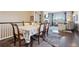 Open-concept dining area with hardwood floors seamlessly connects to the living room with fireplace feature at 5425 E 125Th Pl, Thornton, CO 80241