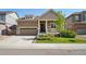 Charming single-Gathering home with a well-manicured lawn, a covered porch, and an attached two-car garage at 5425 E 125Th Pl, Thornton, CO 80241