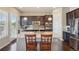 Well-lit kitchen featuring granite counters, stainless steel appliances, an island with seating, and hardwood floors at 5425 E 125Th Pl, Thornton, CO 80241