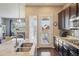 Modern kitchen featuring a granite island, stainless steel appliances, and a view to the outdoor living space at 5425 E 125Th Pl, Thornton, CO 80241