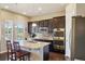 Spacious kitchen featuring granite counters, stainless steel appliances, an island with seating, and hardwood floors at 5425 E 125Th Pl, Thornton, CO 80241