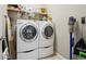 A laundry room with a stacked washer and dryer, wire shelves, and cleaning supplies at 5425 E 125Th Pl, Thornton, CO 80241