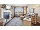 Comfortable living room showcasing a fireplace, large windows and neutral decor at 5425 E 125Th Pl, Thornton, CO 80241