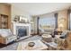 Comfortable living room showcasing a fireplace, large windows and neutral decor at 5425 E 125Th Pl, Thornton, CO 80241