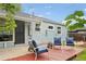 Cozy backyard featuring a red wood deck, comfortable seating, and well-maintained siding and yard at 5445 Nebraska Way, Denver, CO 80246