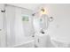 Bright bathroom featuring a shower-tub combo with white marble-look tile, a modern vanity, and natural light at 5445 Nebraska Way, Denver, CO 80246