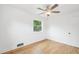 Bright bedroom features hardwood floors, fresh paint, newer window, and ample natural light at 5445 Nebraska Way, Denver, CO 80246