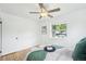 This bright bedroom features hardwood floors, fresh paint, a newer window and ample natural light at 5445 Nebraska Way, Denver, CO 80246