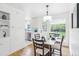 Charming dining area with backyard views, bright lighting and a modern light fixture, and wood flooring at 5445 Nebraska Way, Denver, CO 80246