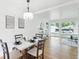 Bright dining room featuring a modern table, stylish light fixture, and large windows offering a neighborhood view at 5445 Nebraska Way, Denver, CO 80246