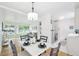 Bright dining area connected to a modern living room and kitchen with ample natural light and hardwood flooring at 5445 Nebraska Way, Denver, CO 80246