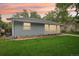 Charming home with lush green lawn and updated siding, trimmed with a brick flowerbed at 5445 Nebraska Way, Denver, CO 80246