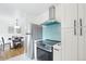 Modern kitchen with stainless steel appliances, light blue backsplash, and open layout to the dining area at 5445 Nebraska Way, Denver, CO 80246