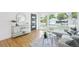 Bright living room featuring hardwood floors, modern decor, and an oversized window with neighborhood views at 5445 Nebraska Way, Denver, CO 80246