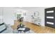 Open living space with hardwood floors, neutral paint, stylish decor, and a view into the dining area at 5445 Nebraska Way, Denver, CO 80246
