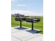 Community BBQ grills on concrete pads providing an outdoor grilling space with grass and neighborhood views at 9855 Biscay St, Commerce City, CO 80022