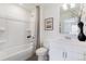 Clean bathroom with a tub and shower combination, complemented by a modern vanity and tasteful decor elements at 9855 Biscay St, Commerce City, CO 80022