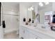 Elegant bathroom with a double vanity, stylish mirrors, and a glass-enclosed shower for a spa-like experience at 9855 Biscay St, Commerce City, CO 80022