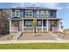 Charming townhome showcasing blue siding, stone accents, and a welcoming front porch with white railings at 9855 Biscay St, Commerce City, CO 80022