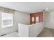 Upstairs hallway with natural light coming from a large window and contemporary decor at 9855 Biscay St, Commerce City, CO 80022