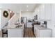 Bright kitchen with a central island featuring white cabinets, stainless steel appliances, and granite countertops at 9855 Biscay St, Commerce City, CO 80022