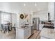 Bright kitchen with a central island, stainless steel appliances, granite countertops, and adjacent dining area at 9855 Biscay St, Commerce City, CO 80022