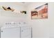Functional laundry room featuring modern appliances, ample counter space, and stylish decor touches, for efficient chore management at 9855 Biscay St, Commerce City, CO 80022