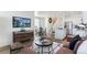 Inviting living room featuring contemporary furnishings, a mounted TV, and an open layout to the kitchen at 9855 Biscay St, Commerce City, CO 80022