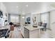 Open concept living area showcasing a kitchen with center island, living room, and dining area at 9855 Biscay St, Commerce City, CO 80022