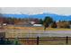 Expansive backyard view with mountains and a white fence, showcasing the serene landscape at 2960 High Prairie Way, Broomfield, CO 80023