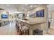 Home bar with granite countertop and seating for entertaining guests at 2960 High Prairie Way, Broomfield, CO 80023